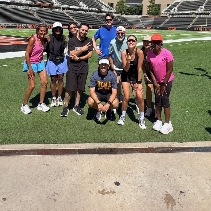Fleet Feet running group posing together at Princeton Stadium